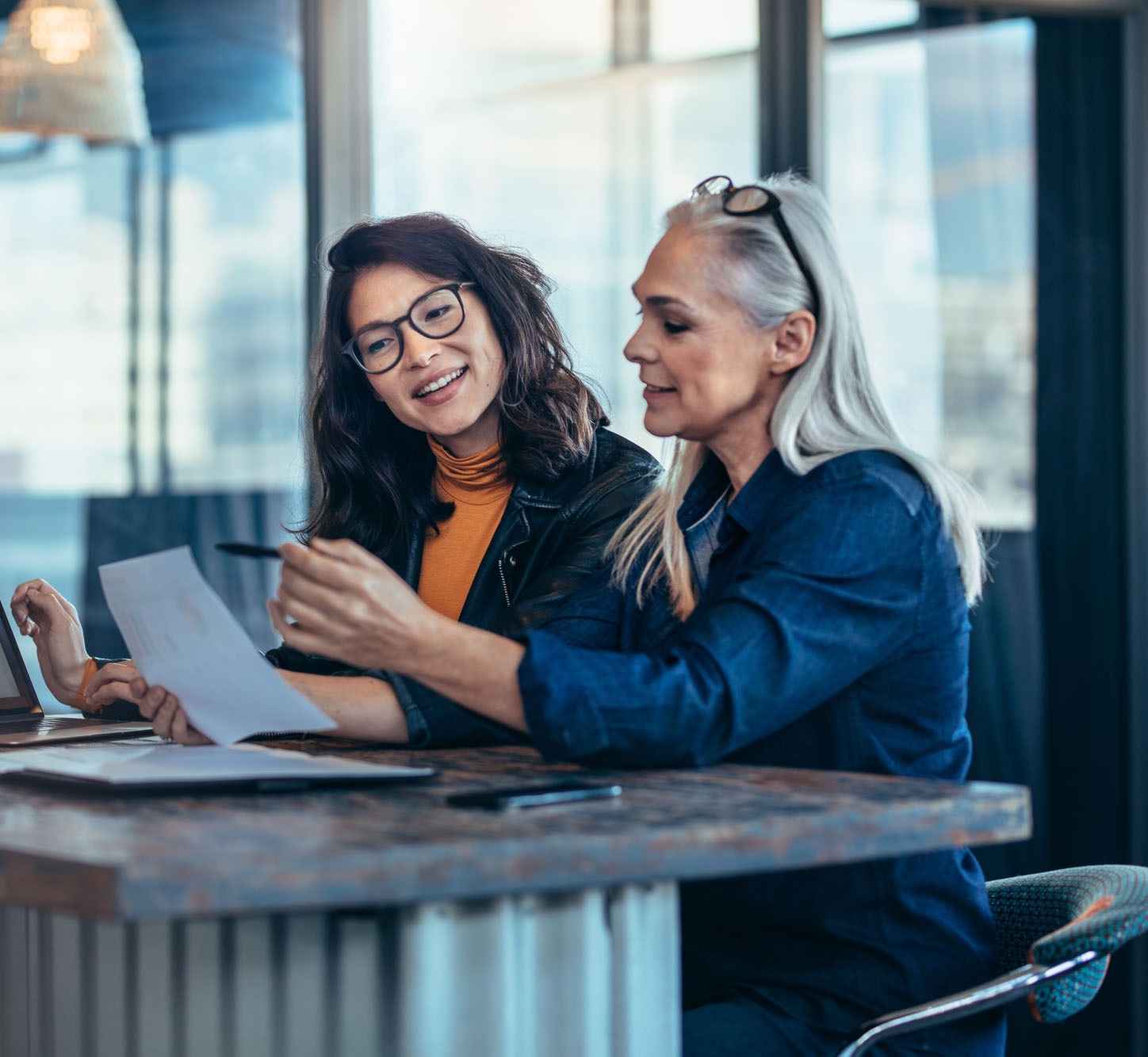 Business professional engaged in work at a laptop in a modern office setting, reflecting focus and concentration. Ideal for productivity topics.