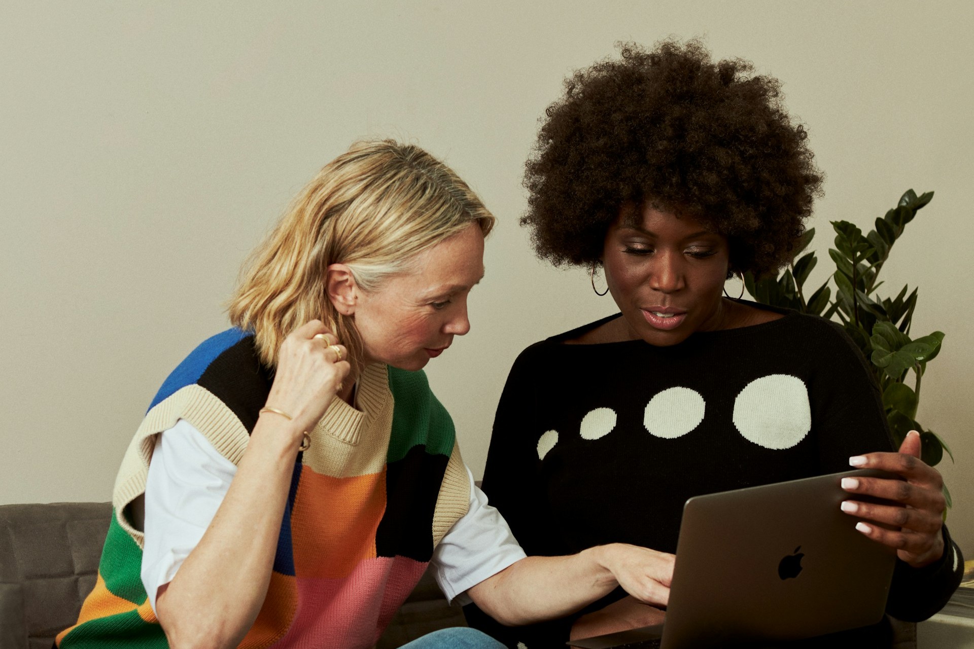 Two women in deep discussion by a computer. Individual Mentoring, Deep Listening.